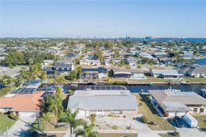 Aerial perspective of suburban area featuring a nearby body of water