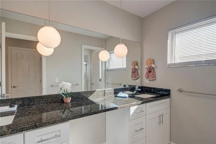 Bathroom with vanity and baseboards