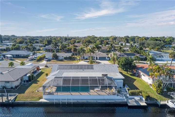 Aerial view of residential area featuring a nearby body of water