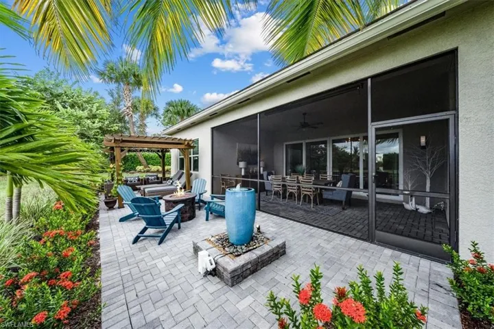 View of patio / terrace with a pergola, ceiling fan, and a fire pit