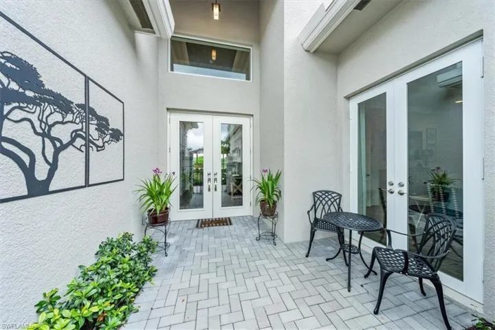 Entrance to property featuring a patio and french doors