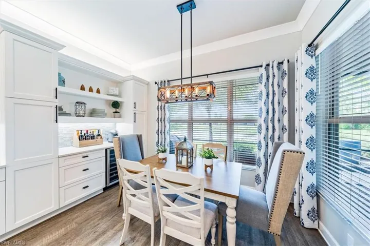 Dining space featuring a notable chandelier and dark hardwood / wood-style flooring