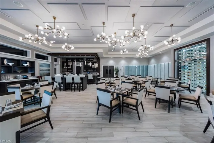 Dining room with an inviting chandelier and light hardwood / wood-style flooring