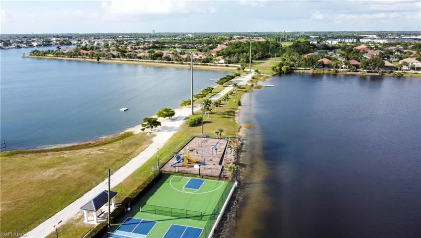 Aerial view of residential area featuring a nearby body of water