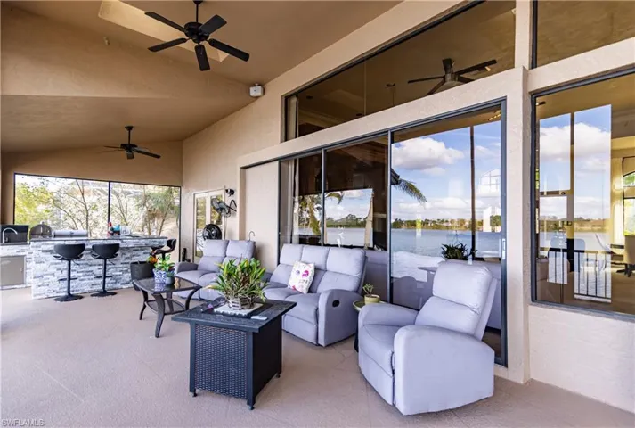View of patio featuring ceiling fan, area for grilling, and an outdoor hangout area