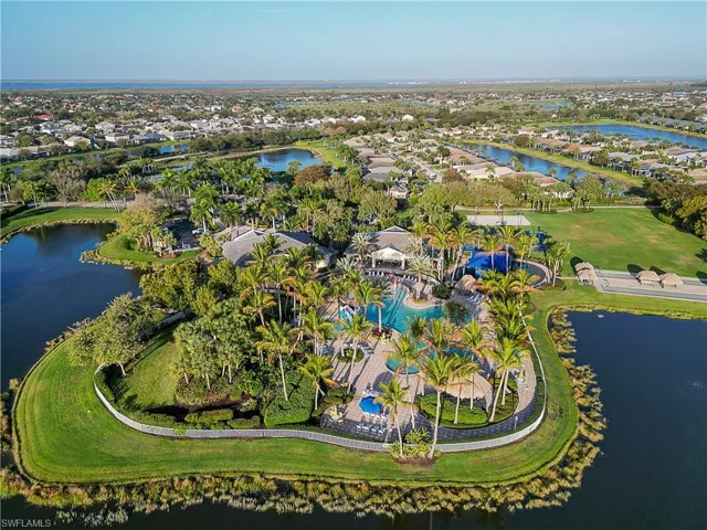 Aerial view of property and surrounding area with a nearby body of water and nearby suburban area