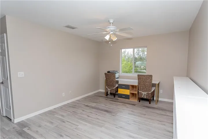 Office featuring light wood-style floors and ceiling fan