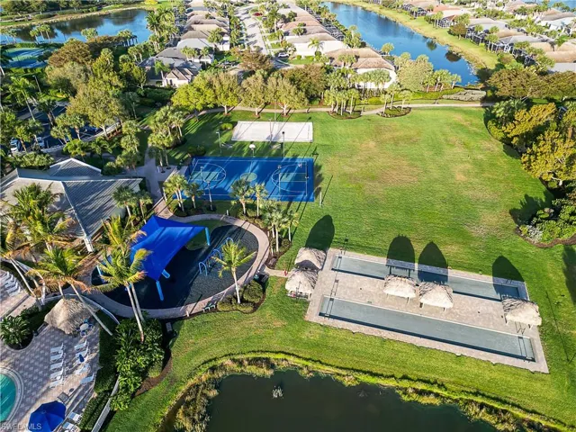Aerial view of residential area featuring a nearby body of water