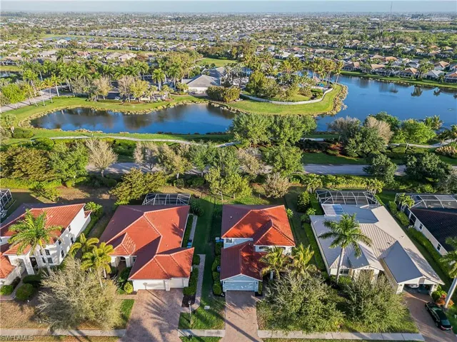Aerial perspective of suburban area featuring a nearby body of water