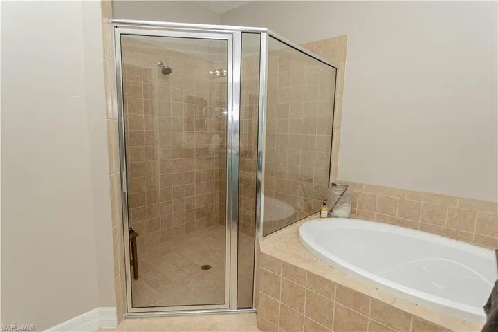Bathroom with a stall shower and a garden tub