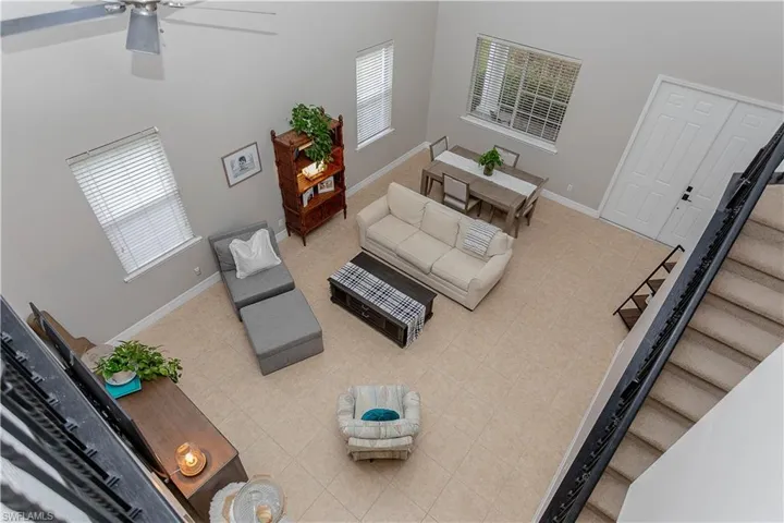 Living area featuring a high ceiling and a ceiling fan