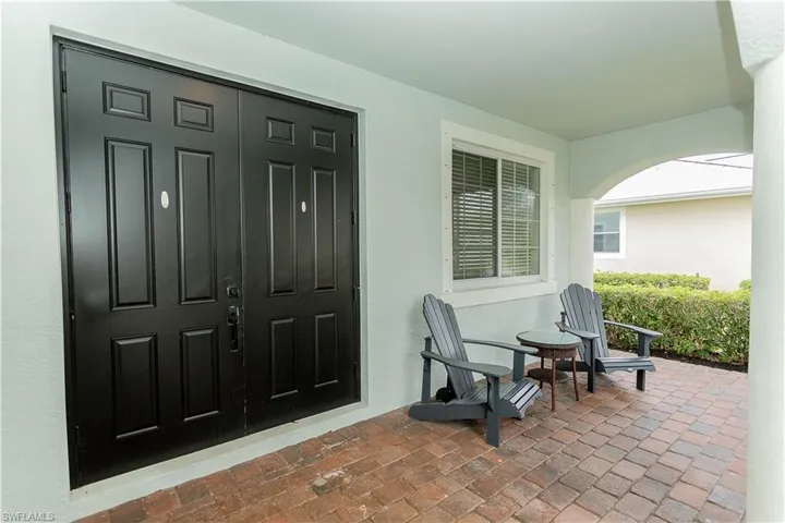 Entrance to property with stucco siding