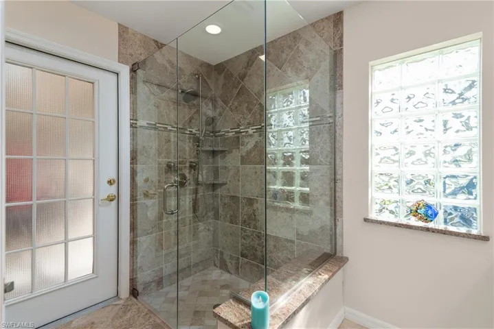 Bedroom featuring light tile patterned flooring, baseboards, and ceiling fan