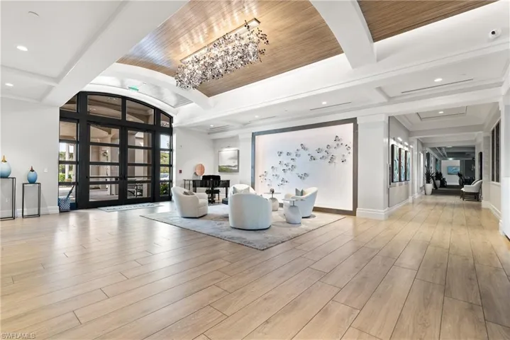Dining room with wood finished floors, a healthy amount of sunlight, and beamed ceiling