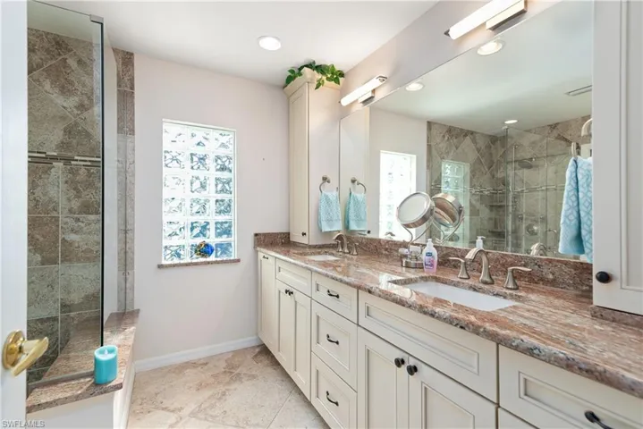 Full bath with a shower stall and recessed lighting