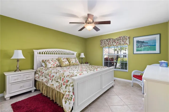 Tiled bedroom featuring a closet, ceiling fan, and visible vents