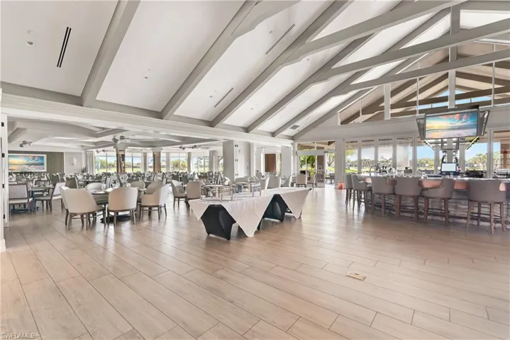 Dining room with ceiling fan, high vaulted ceiling, a workshop area, and beam ceiling
