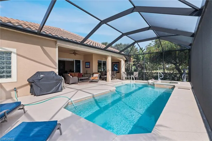 View of swimming pool with a pool with connected hot tub, ceiling fan, grilling area, outdoor lounge area, and a patio area