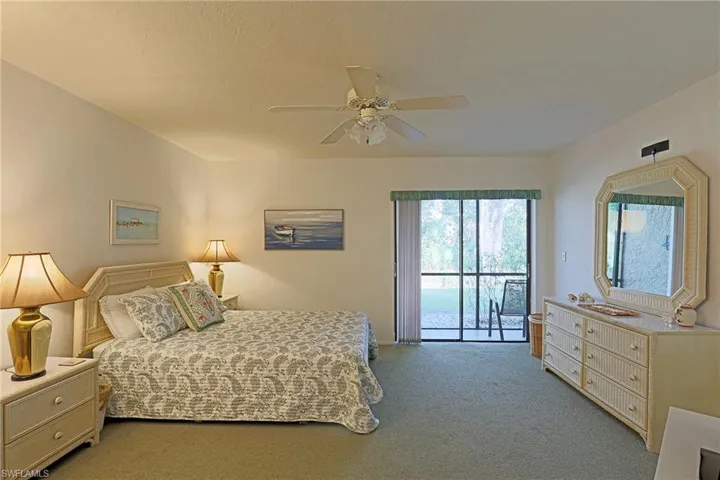 Bedroom with access to exterior, light carpet, and ceiling fan