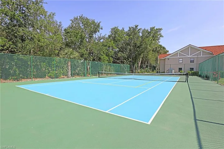 View of tennis court featuring community basketball court