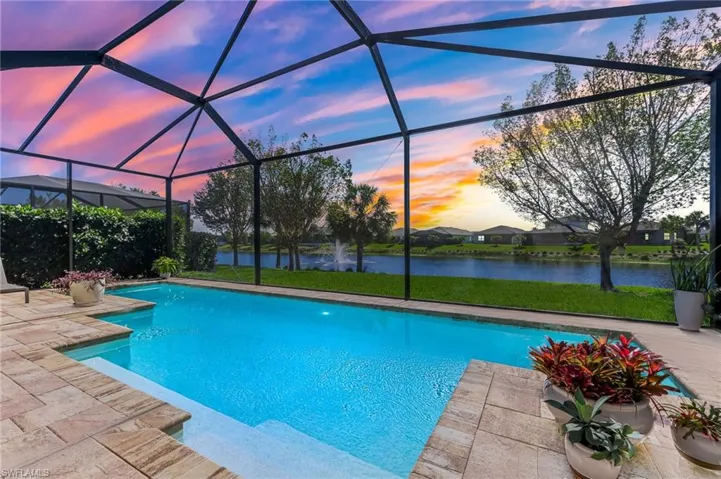 Outdoor pool featuring a patio area, a lanai, and a water view