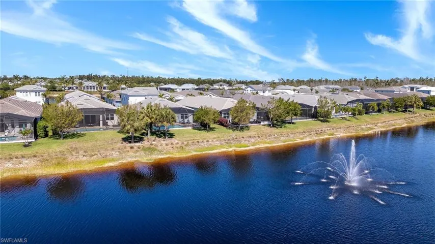 Drone / aerial view with a residential view and a water view