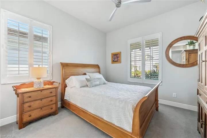 Bedroom featuring baseboards, carpet floors, and ceiling fan