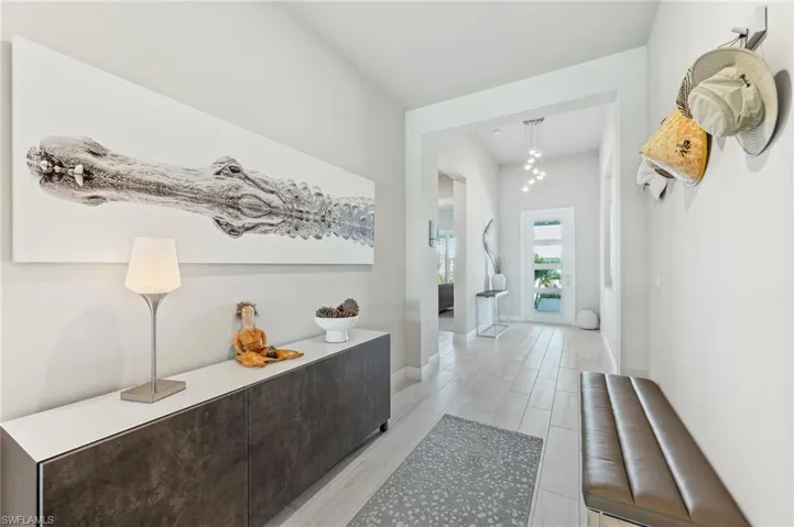 Corridor with baseboards and light wood-style flooring