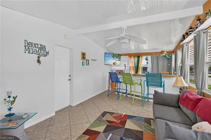 Vaulted ceiling with white paneling and exposed beams