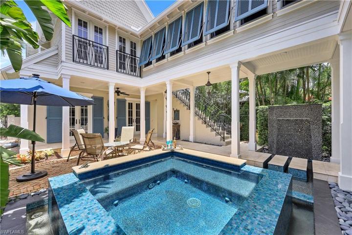 Pool/large spa combo surrounded by brick deck, guest sute, stairs to master, water feature plus covered lanai!