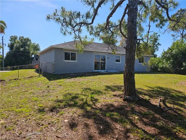 Back of house featuring a lawn
