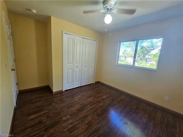 Unfurnished bedroom featuring ceiling fan, a closet, and hardwood / wood-style floors