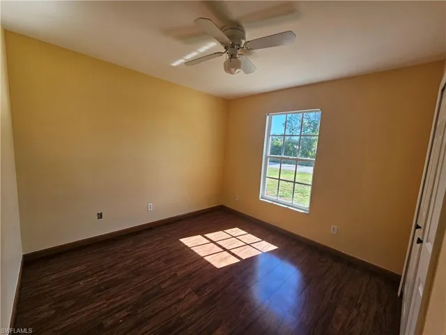 Unfurnished room featuring ceiling fan and wood-type flooring