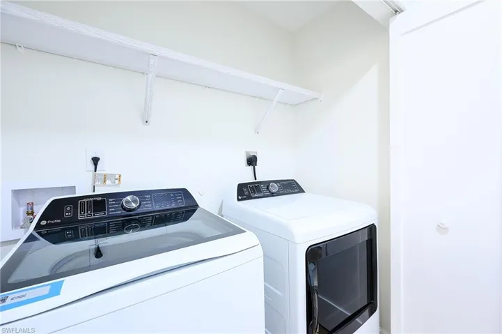Clothes washing area featuring washing machine and clothes dryer
