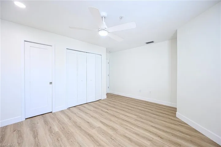 Unfurnished bedroom featuring ceiling fan and light hardwood / wood-style floors