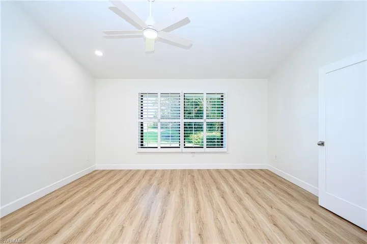 Master bedroom featuring ceiling fan and light wood-type flooring