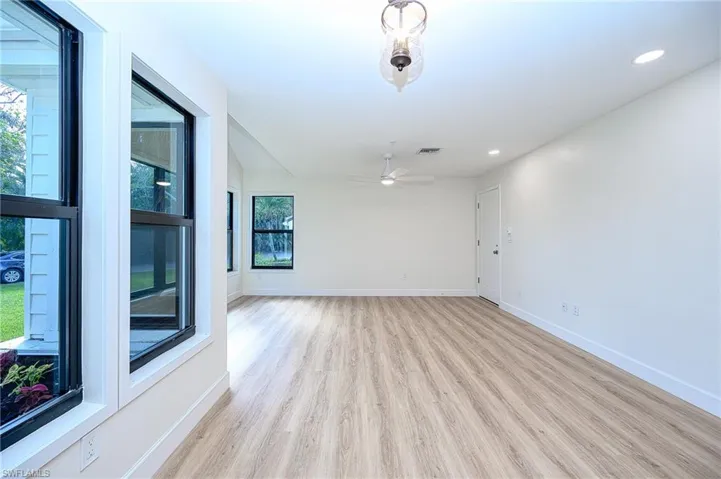 Spare room featuring ceiling fan and light wood-type flooring