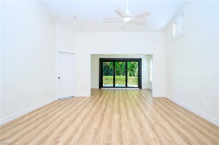 Unfurnished living room featuring light wood-type flooring and ceiling fan