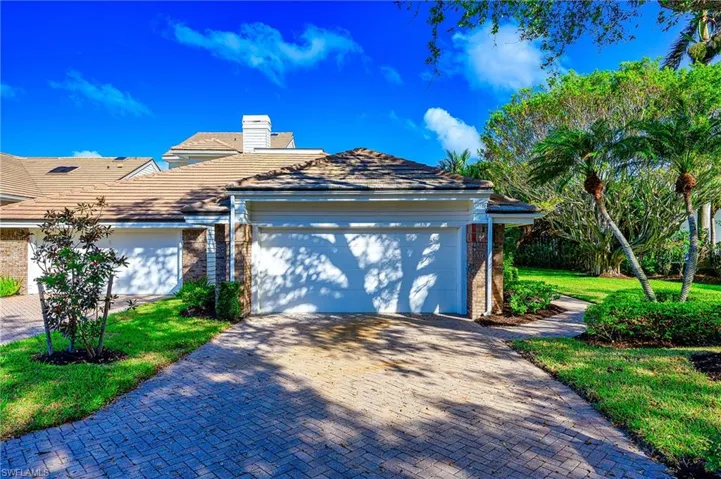 View of front of home with oversized 2 car garage and a front yard