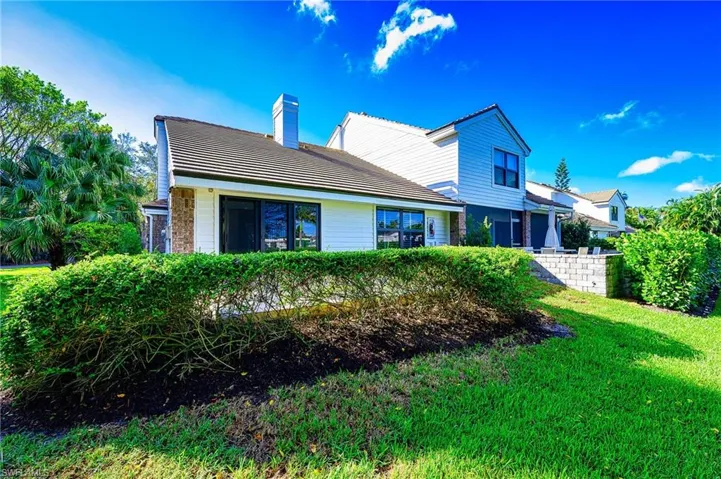 Rear view of house with a lawn