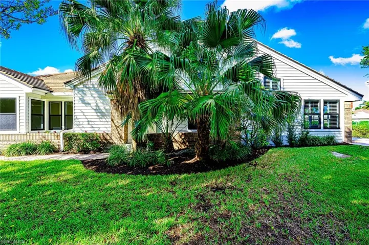 View of side of home featuring a yard