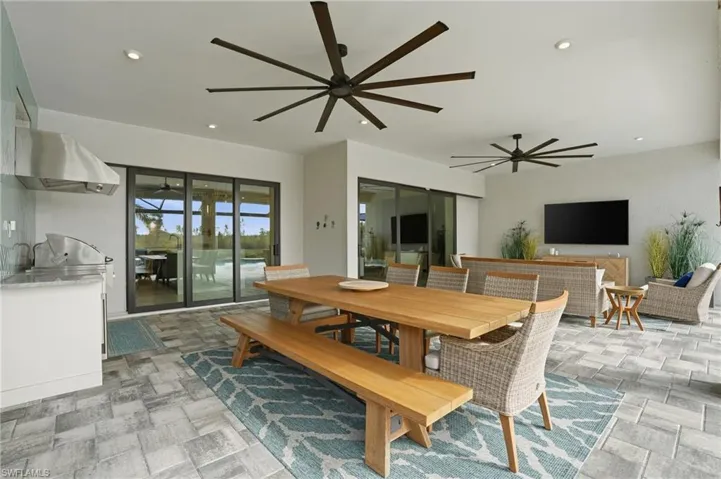Dining room with recessed lighting and a ceiling fan