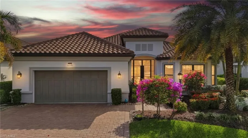Mediterranean / spanish-style house with an attached garage, decorative driveway, stucco siding, and a tiled roof