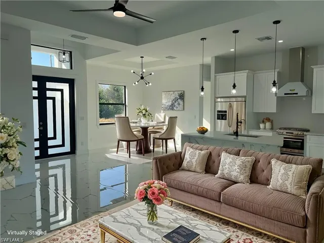 virtually Staging Living room with ceiling fan with notable chandelier, marble finish floor, and visible vents