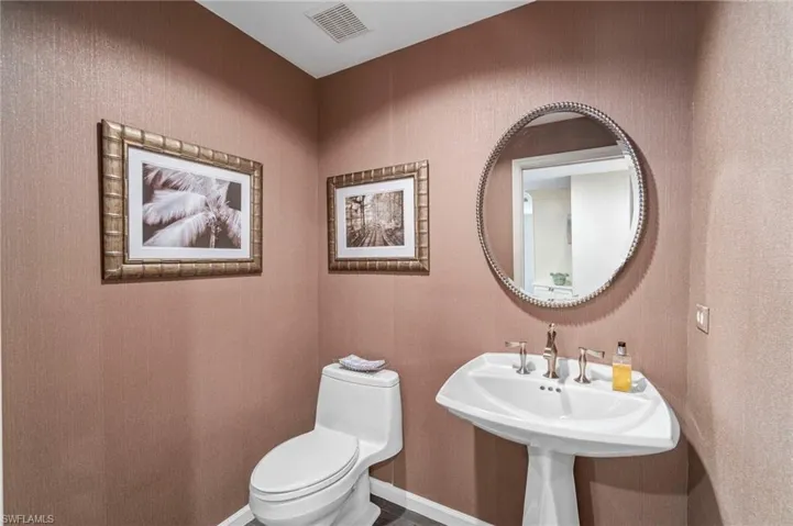 Bathroom with toilet and baseboards