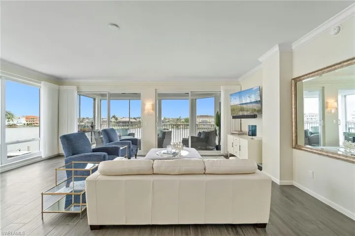 Living area featuring crown molding and wood finished floors
