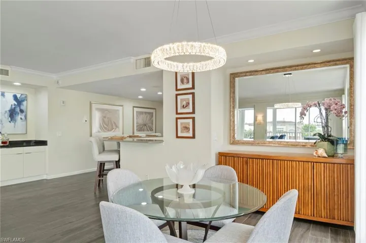 Dining space featuring ornamental molding, recessed lighting, and dark wood-style floors