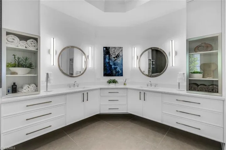 Full bathroom with double vanity and dark tile patterned flooring