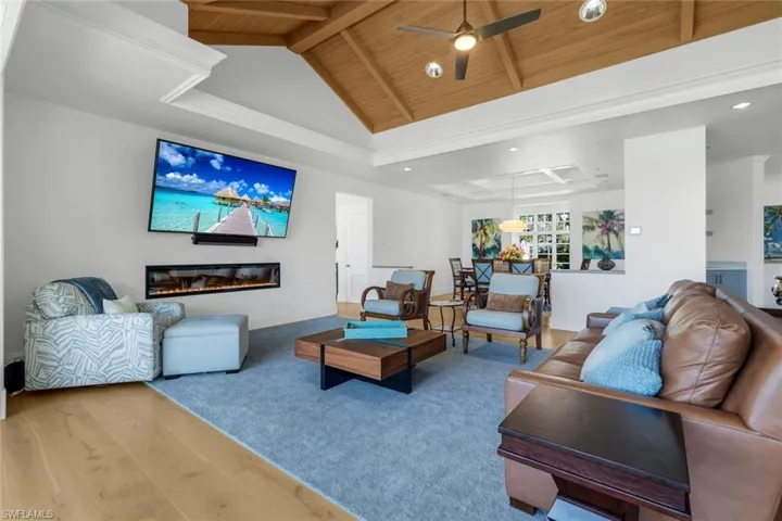 Living area featuring wood finished floors, high vaulted ceiling, a wood ceiling with exposed beams, ceiling fan, and recessed lighting