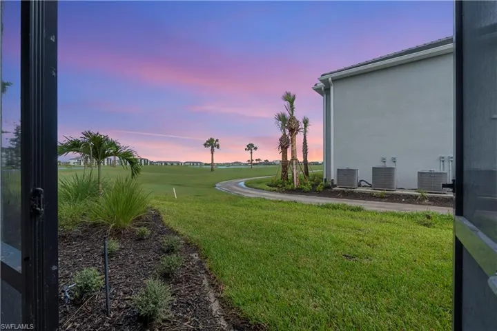 Expansive lawn with integrated landscaping and mature palm trees